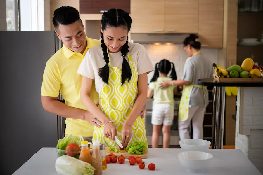 A picture of a happy Asian family in the kitchen