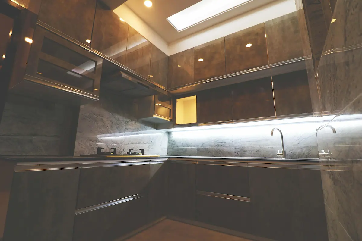 A view of a kitchen with a dark marble design