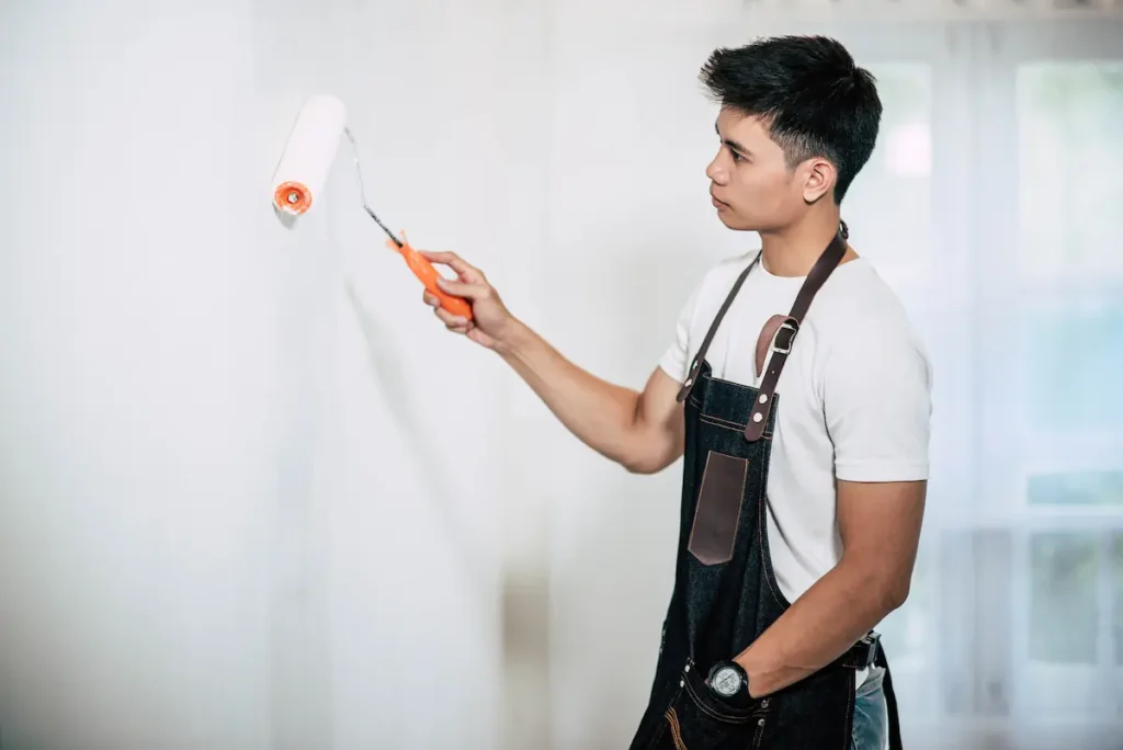 A man painting the wall white