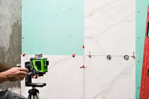 A man working on tiling during a renovation